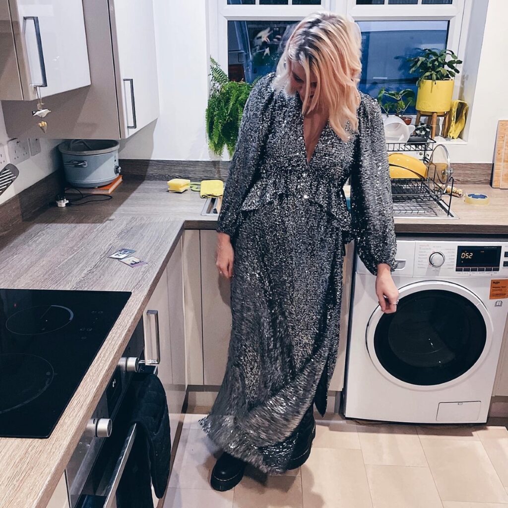 Image of woman with peach hair in silver sequin dress